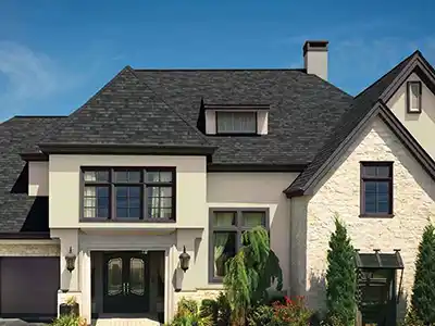 Light tan home with a black shingle roof